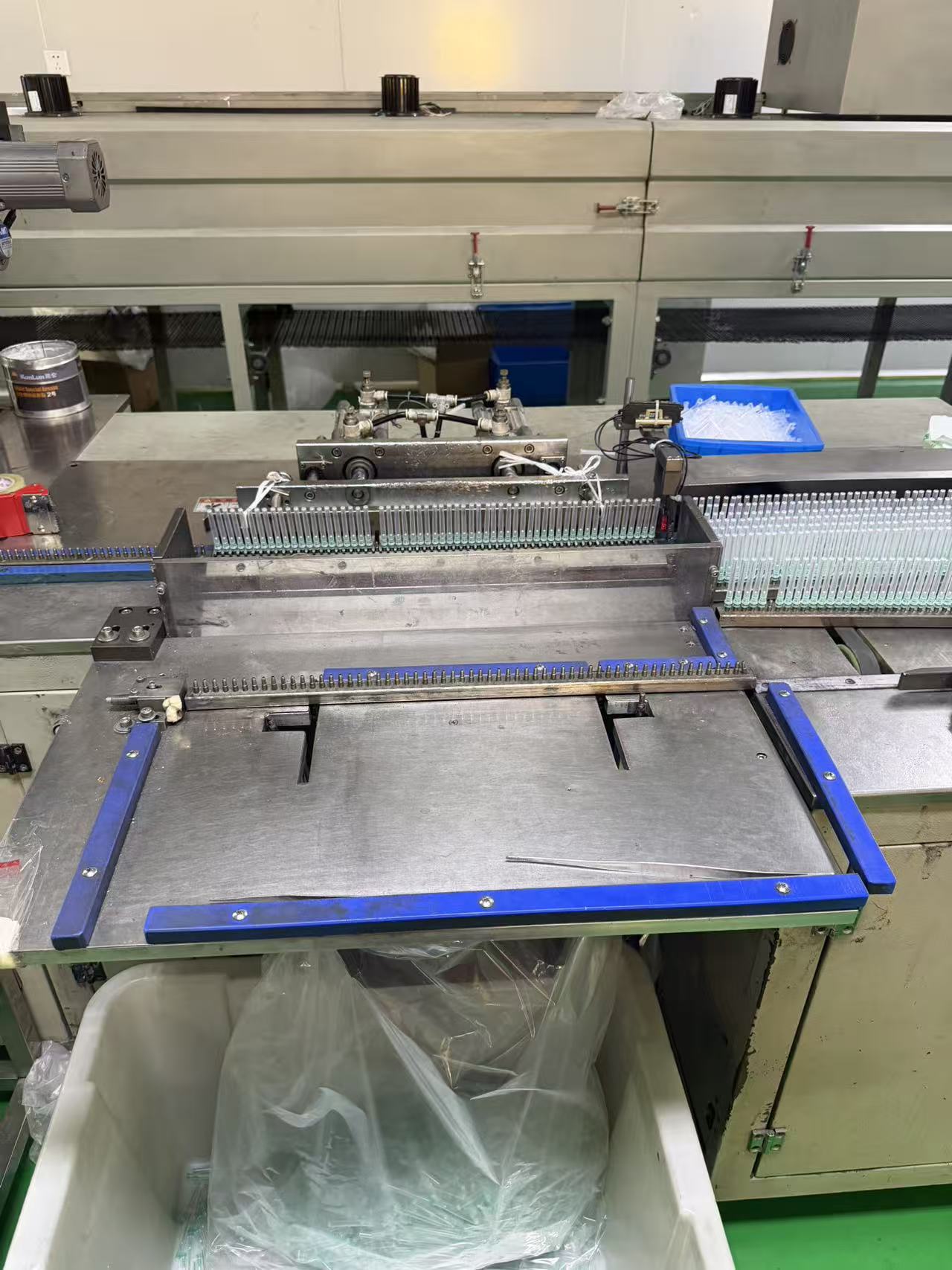 Adhesive needle applicator.