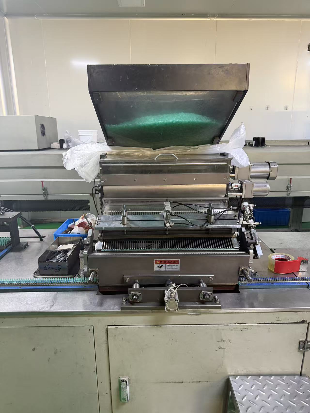 Adhesive needle applicator.