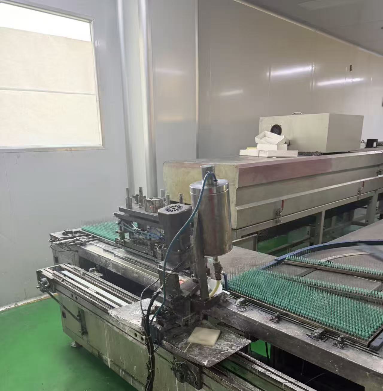 Adhesive needle applicator.