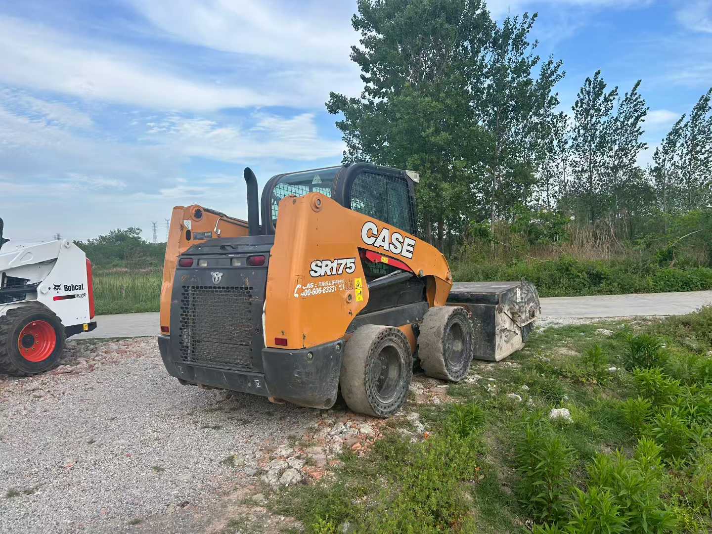 Two CASE Case SR175 sliding loader machines.