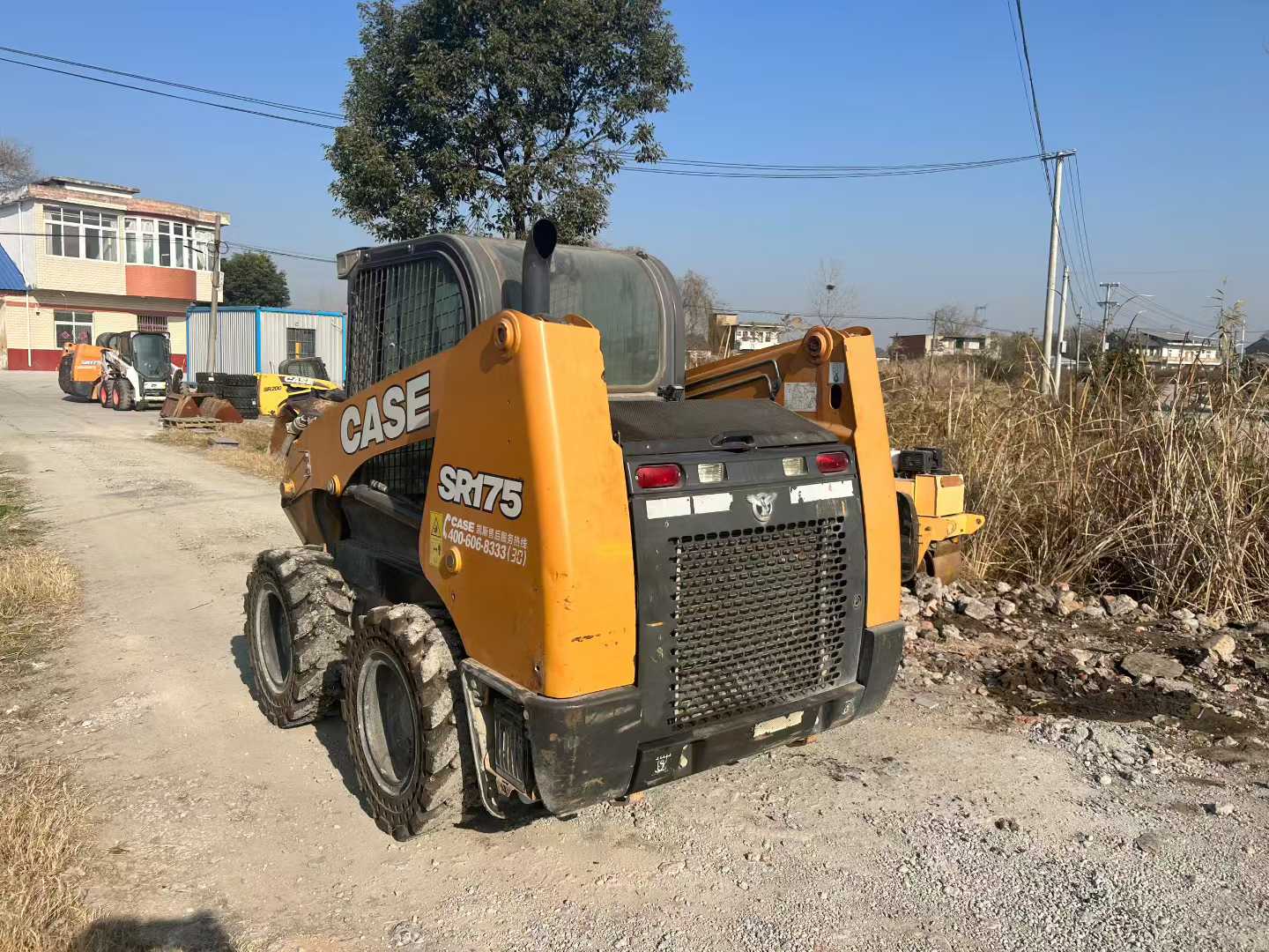 Two CASE Case SR175 sliding loader machines.