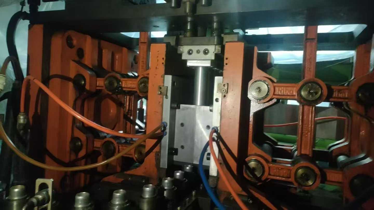 RiBo Blow Molding Machine, one output for six units, with three sets of molds.