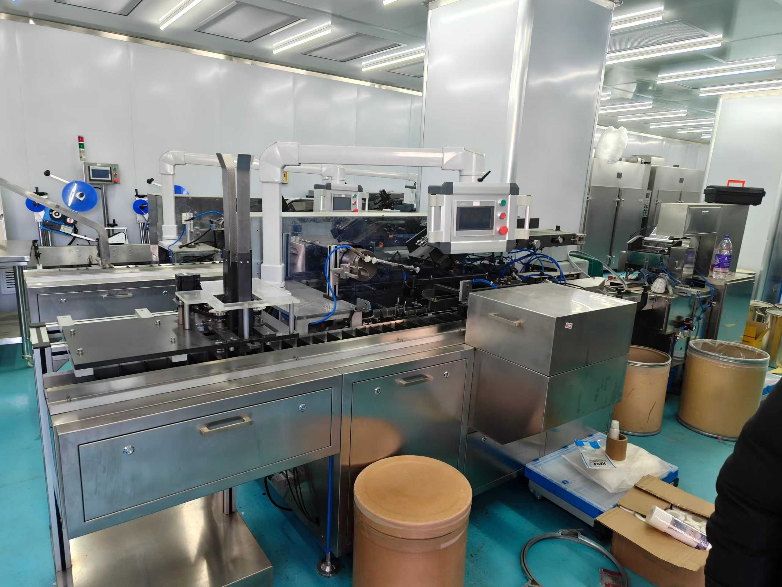 Boxing machine with adhesive application function + transparent film packaging machine.